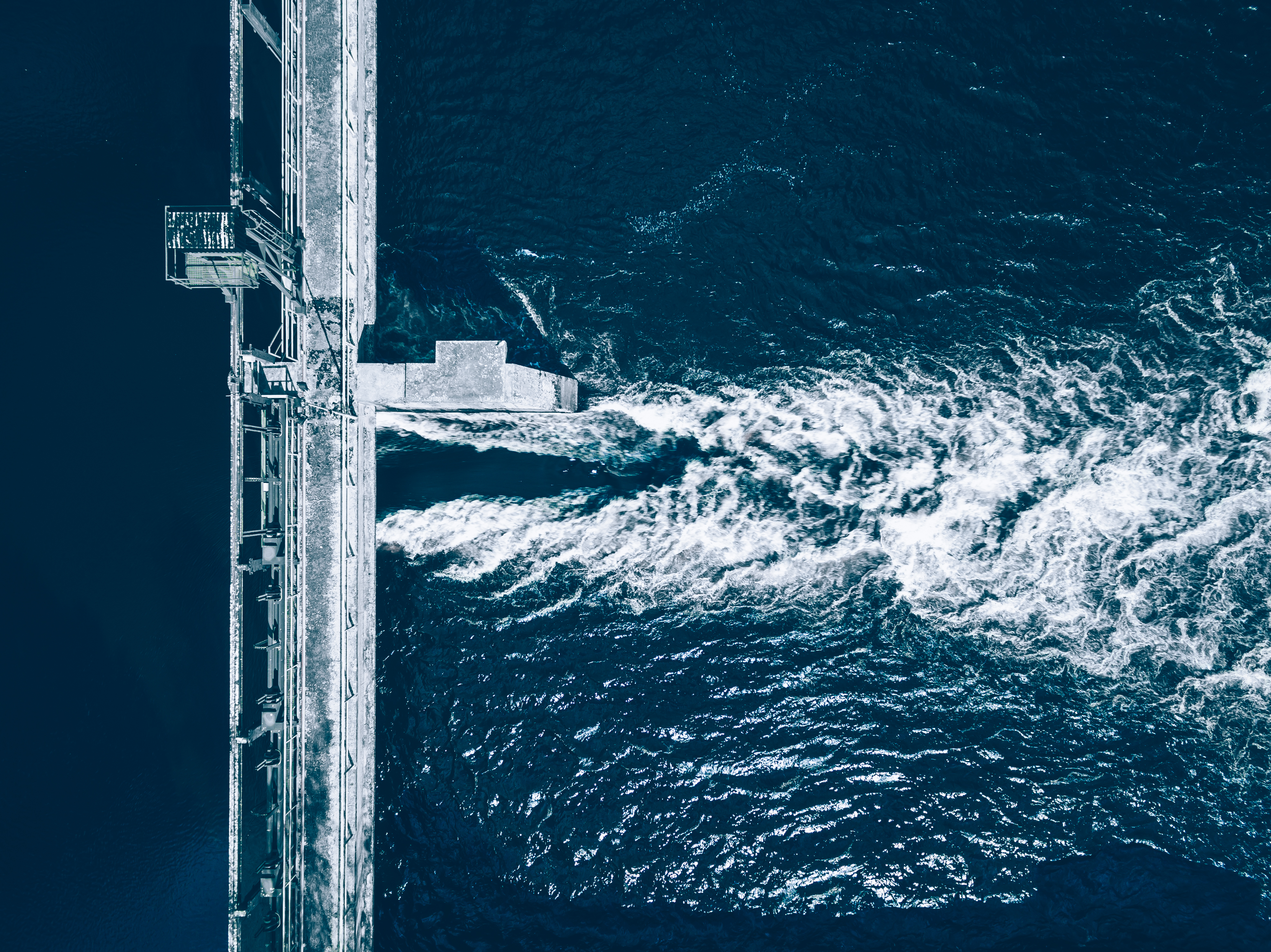 Aerial view of a dam releasing water, water flowing downstream in Finland. Drone view. Credit: wmaster890 iStock